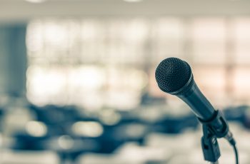Microphone voice speaker in seminar classroom, lecture hall or conference meeting in educational business event for host, teacher, or coaching mentor